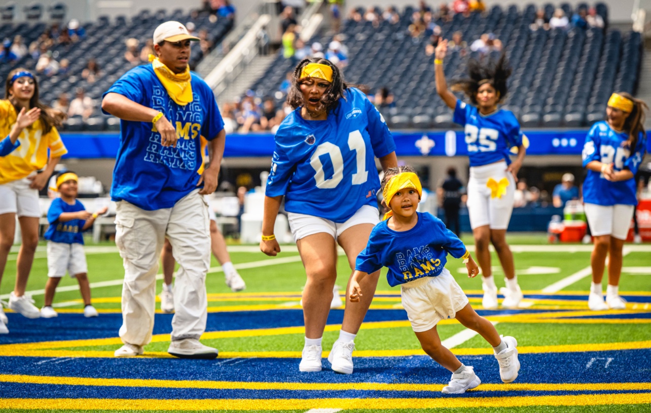 Origin dancers performing on the stadium field