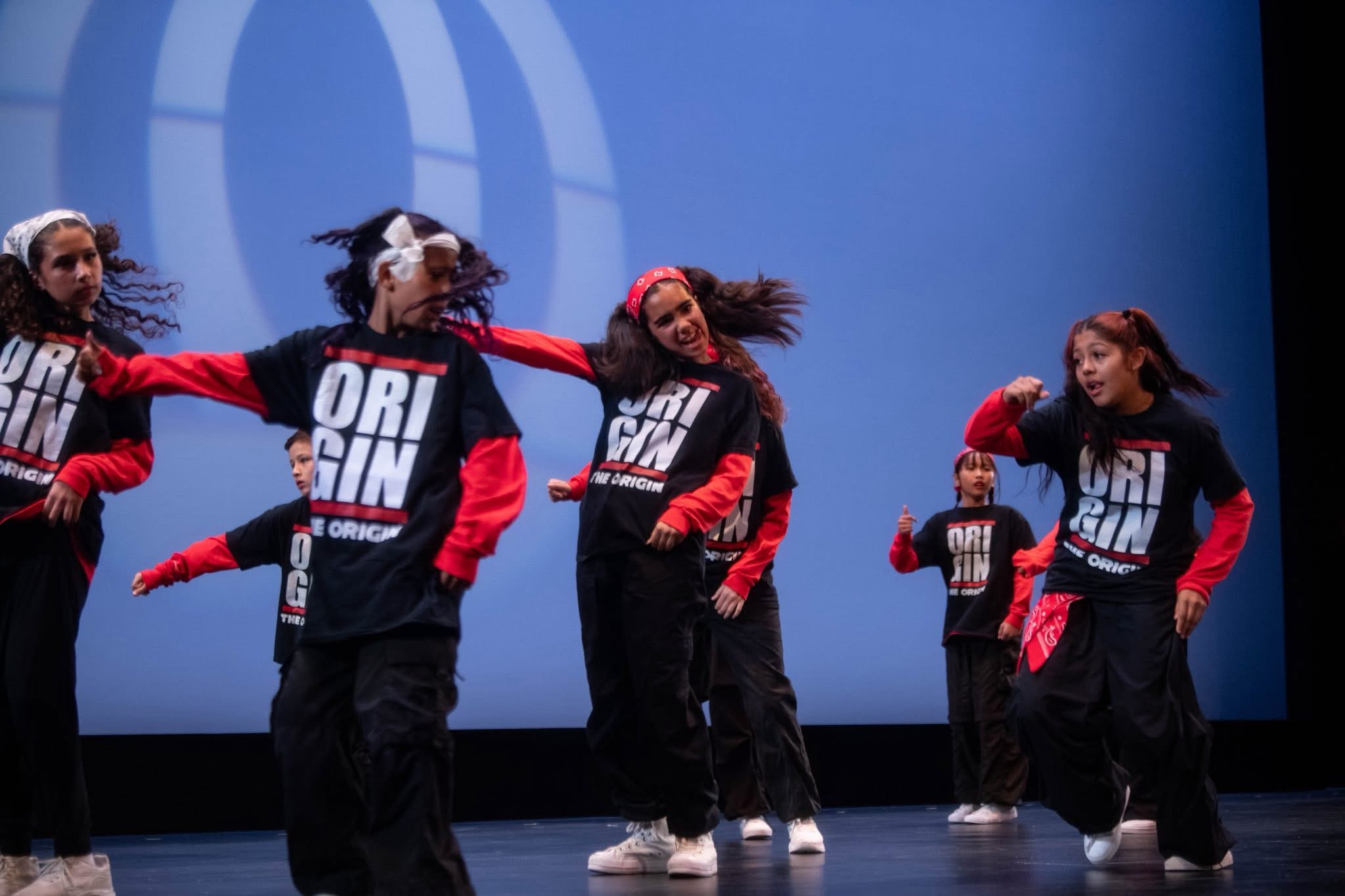 The Origin crew performing on stage